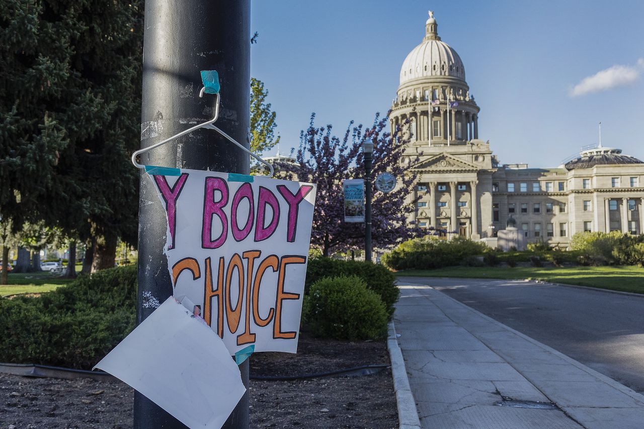 A sign reading "My body, my Choice," is taped to a hanger taped to a streetlight in front of the Idaho State Capitol Building
