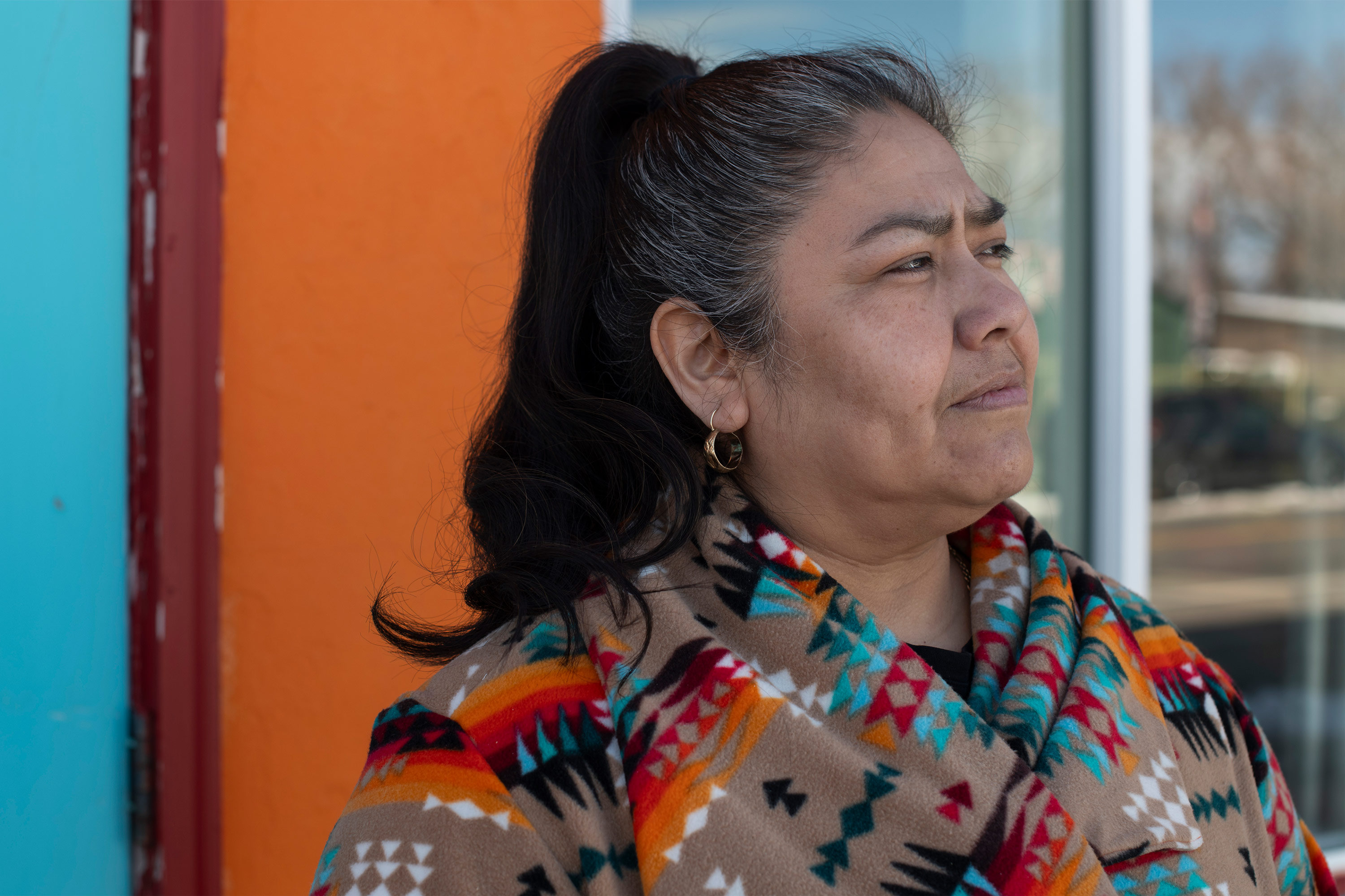 A photo of a woman posing outside.